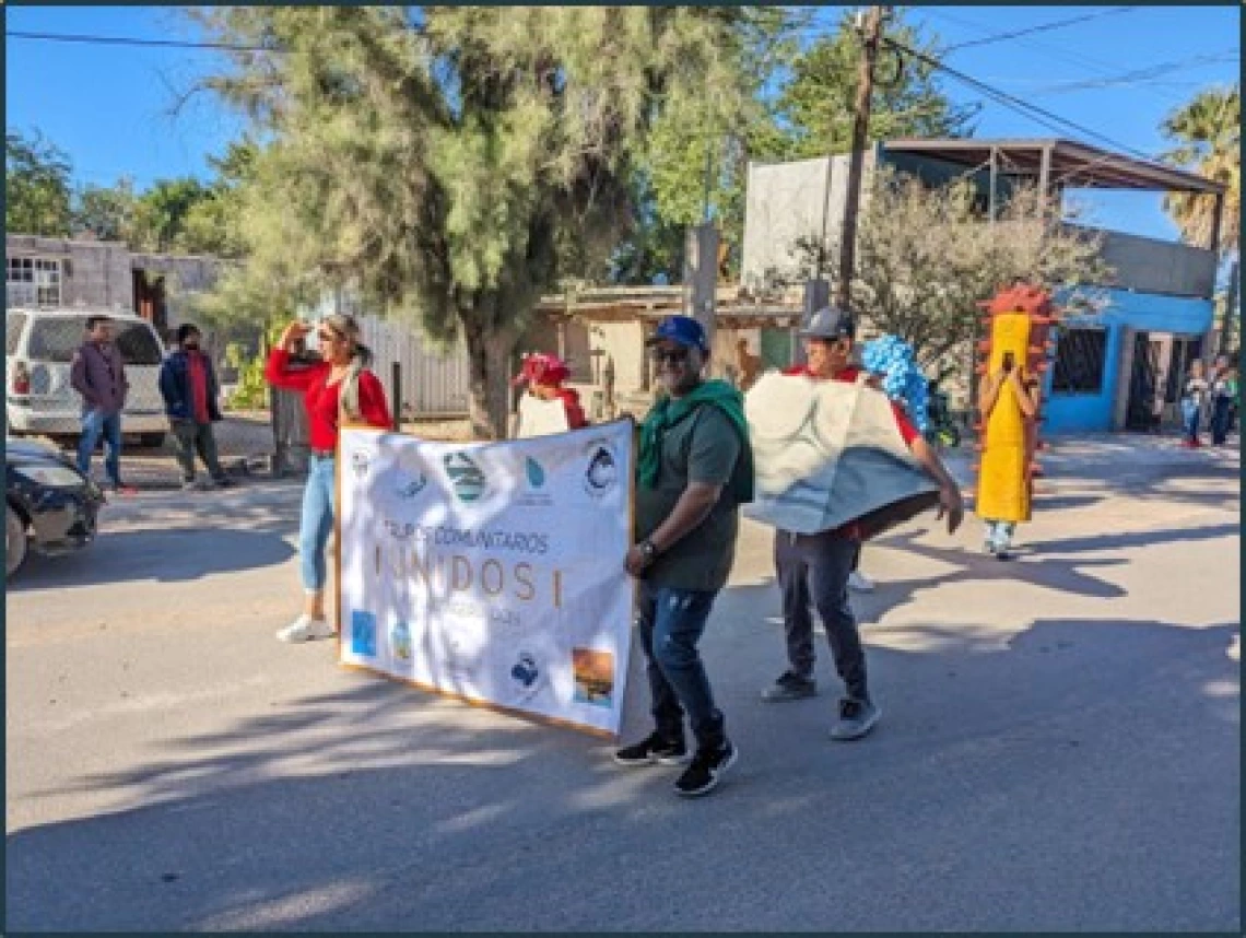 Photo 1: Members of various community groups at the annual November Desfile de la Revolución in Kino