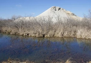 A large chat pile towers behind Tar Creek.