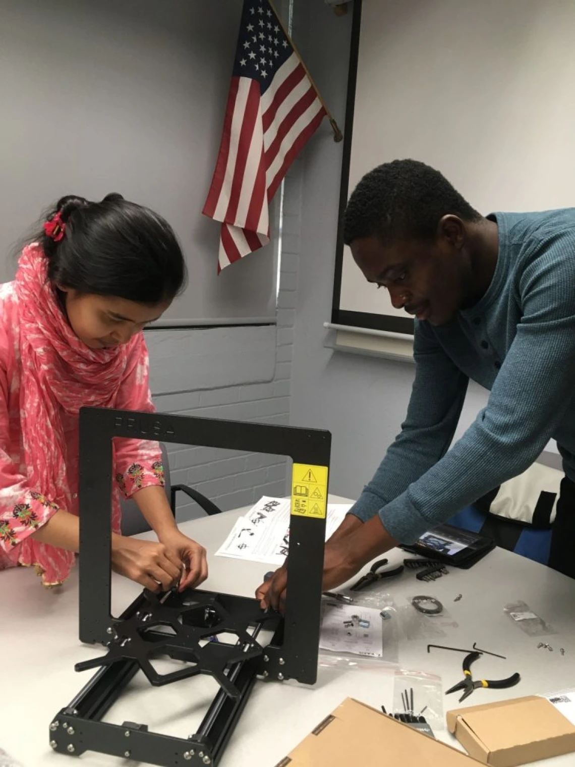 Fig.1. Setting up a new 3D printer in the lab for sustainability research.