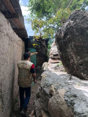 Local resident pointing out the height of previous flood waters, Villanueva, Honduras.
